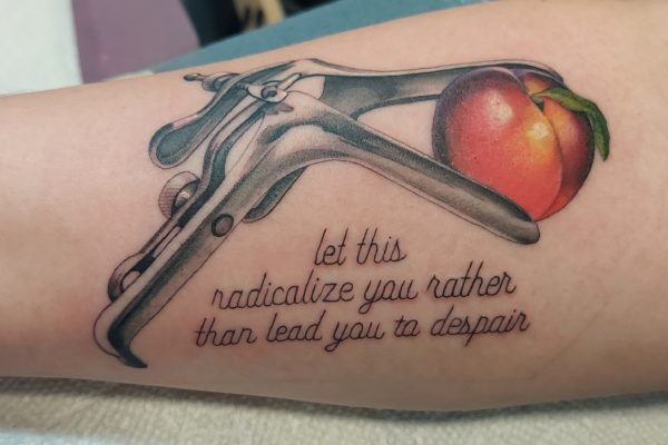 tattoo of a speculum holding a nectarine with the text "Let this radicalize you rather than lead you to despair"